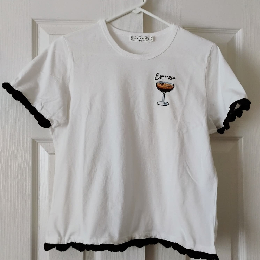 Chic White Tee with Black Ruffle Trim and Embroidered Cocktail